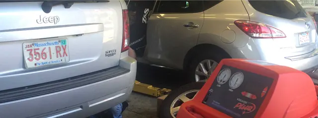 Air conditioning service machine hooked up to a Jeep