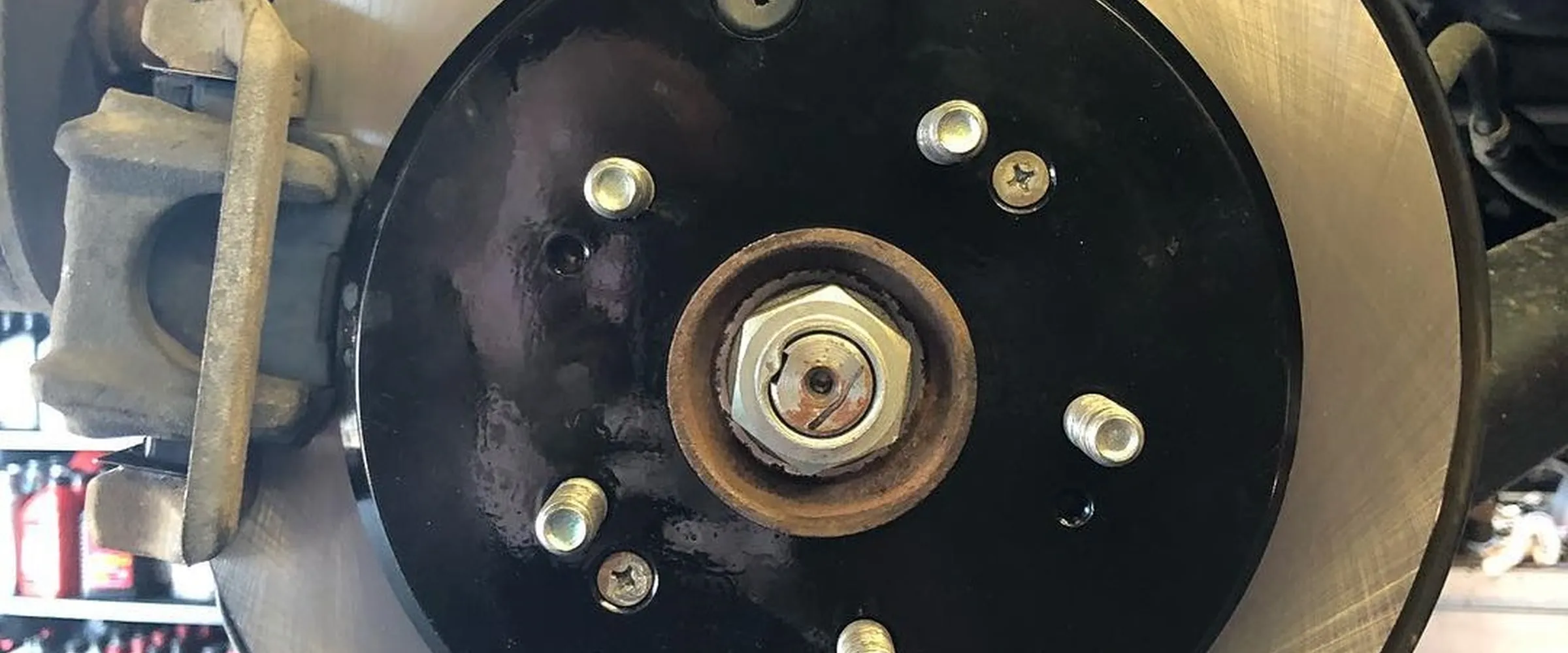 New slotted rotor and red caliper after a brake job