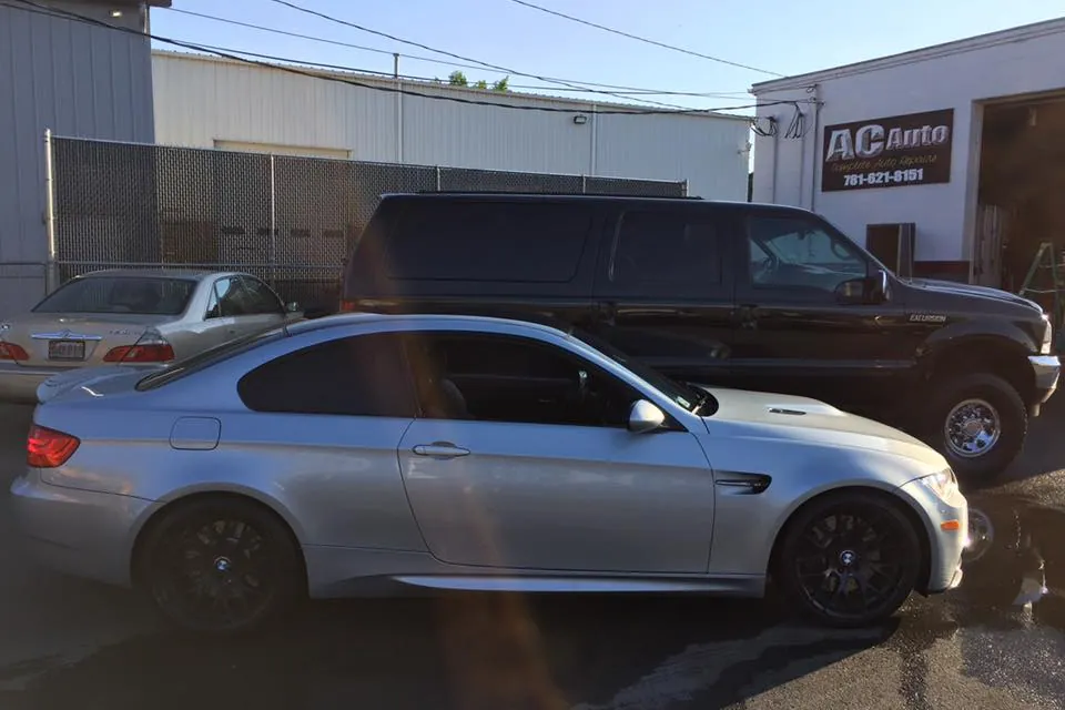 BMW M3 parked in front of the AC Auto sign