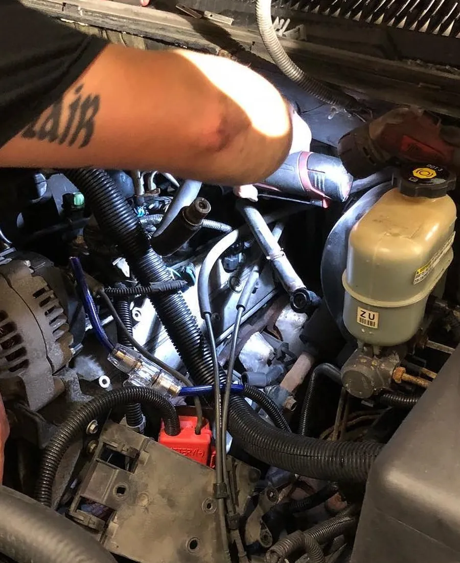 Hands at work in an engine bay